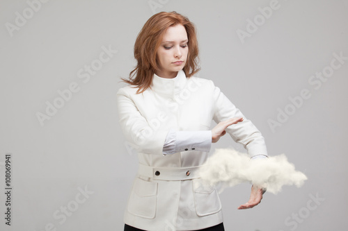 Young woman holding cloud, cloud computing concept