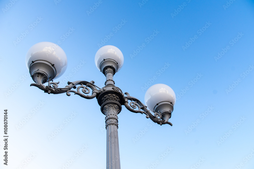 Antique style street lamp in europe, blue sky background Antique style street lamp in europe, blue sky background