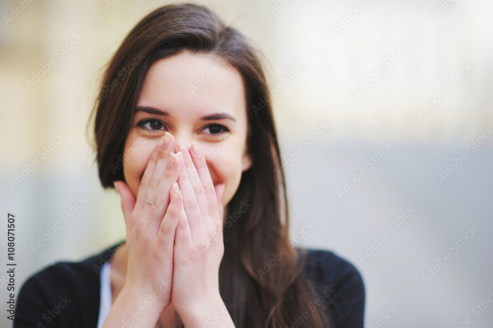 young beautiful girl covering her mouth with his hands for joy young beautiful girl covering her mouth with his hands for joy