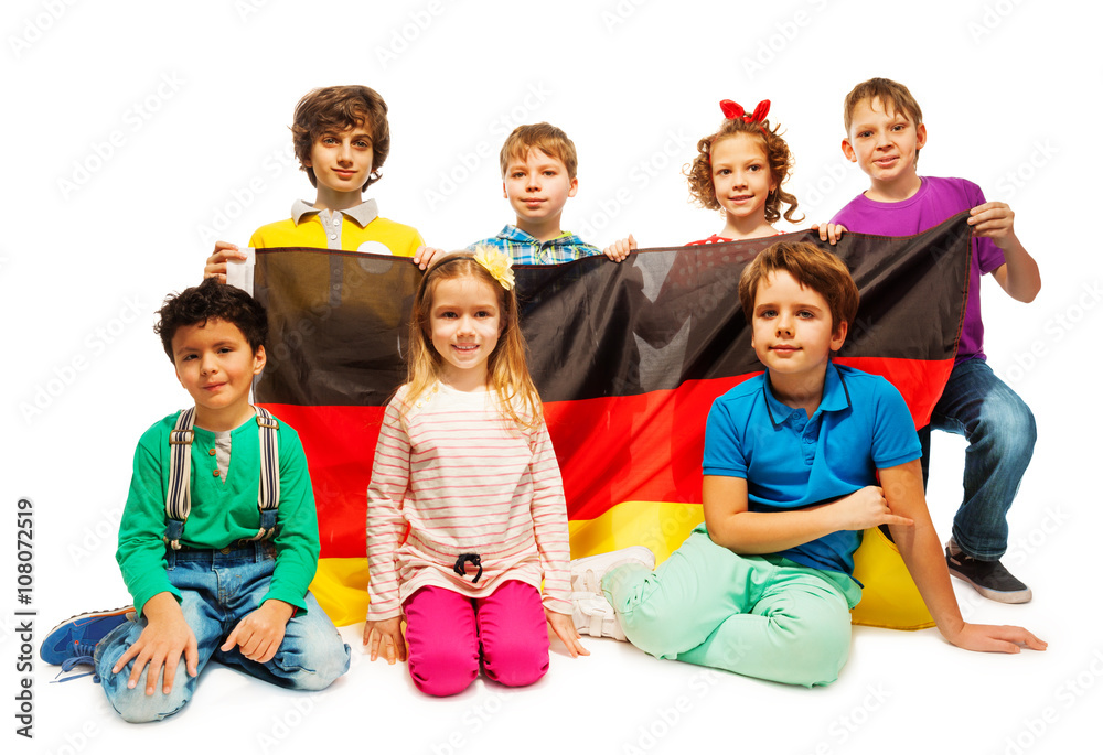 Group of seven children sitting with a German flag Group of seven children sitting with a German flag