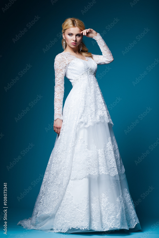 beautiful bride in wedding dress on blue beautiful bride in wedding dress on blue