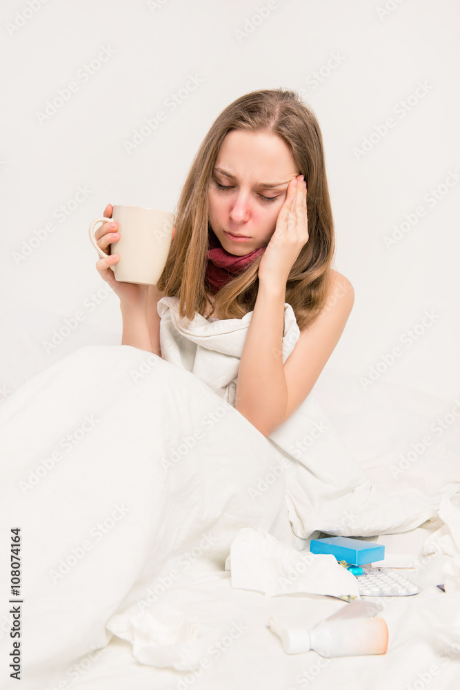Portrait of sick woman with grippe and headache holding cup of h Portrait of sick woman with grippe and headache holding cup of h