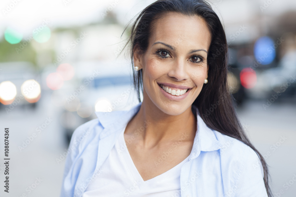 Close up of Hispanic woman smiling outdoors Close up of Hispanic woman smiling outdoors