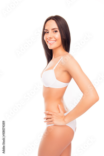 Side view photo of cheerful smiling young woman in white lingeri