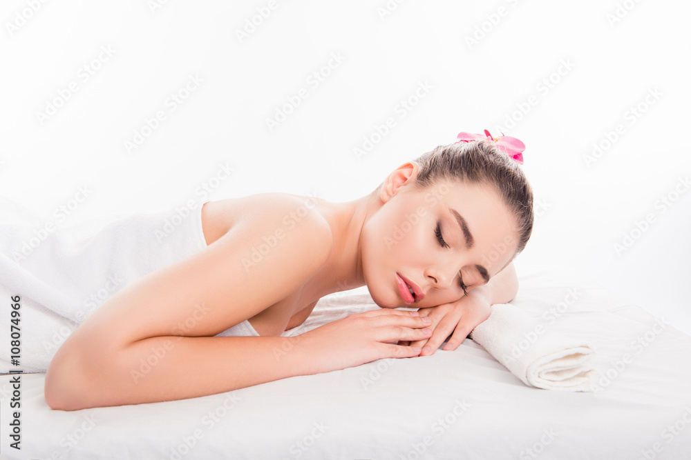 Side view of pretty young woman laying in spa salon with closed Side view of pretty young woman laying in spa salon with closed