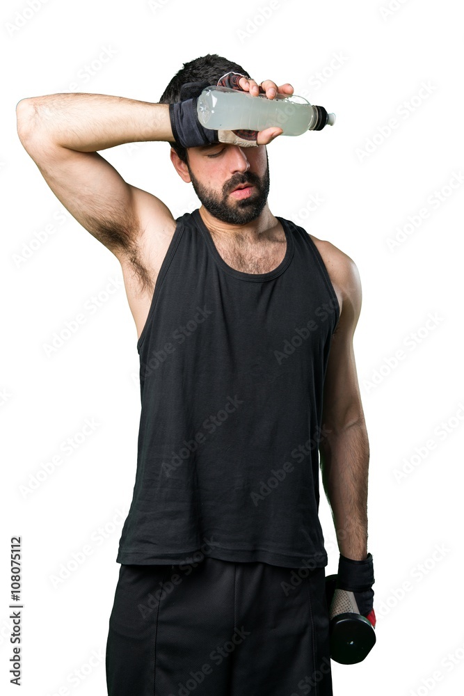 Sportman doing weightlifting drinking water soda Sportman doing weightlifting drinking water soda