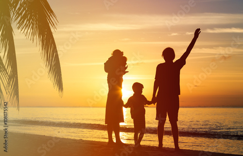 happy family with two kids having fun at sunset