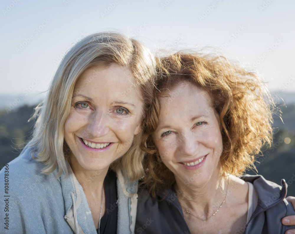 Close up of smiling Caucasian women hugging Close up of smiling Caucasian women hugging
