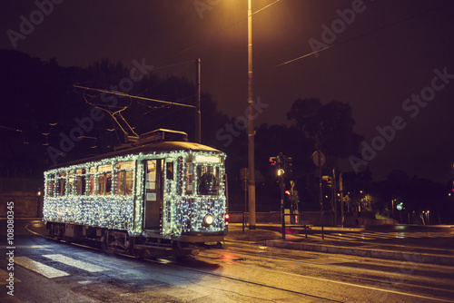 Illuminated streetcar on city street, Rome, Italy