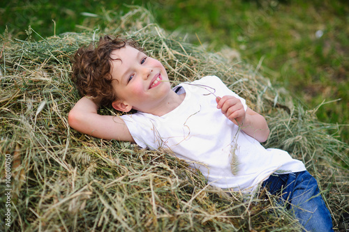 baby lying on the hay