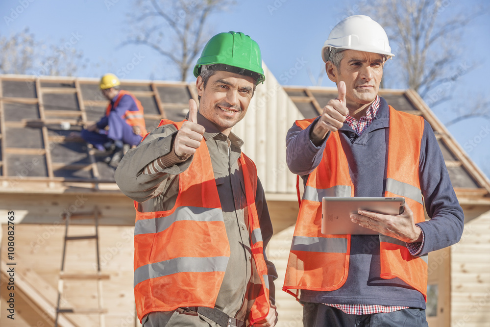 Foreman and layman on construction site Foreman and layman on construction site