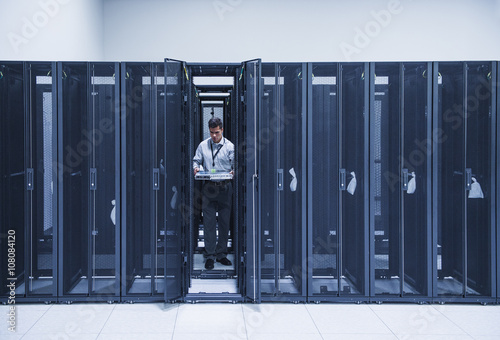 Hispanic technician working in server room