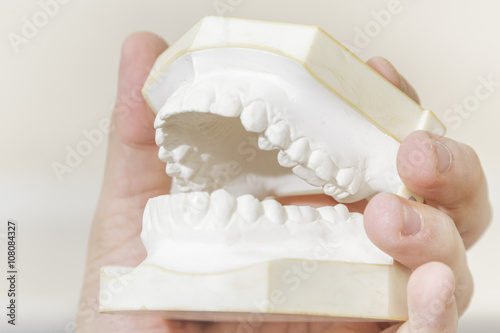 фотографія Man holding dental casting