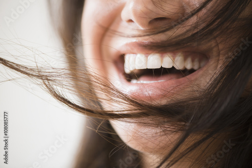 Close up of laughing woman with messy hair photo