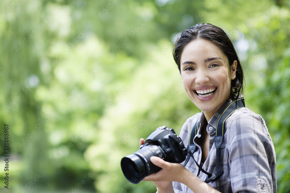 Hispanic woman photographing outdoors Hispanic woman photographing outdoors