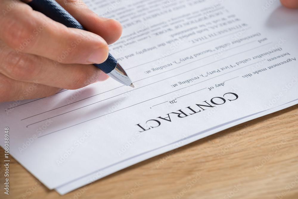 Businessman Hand Holding Pen On Contract Paper Businessman Hand Holding Pen On Contract Paper