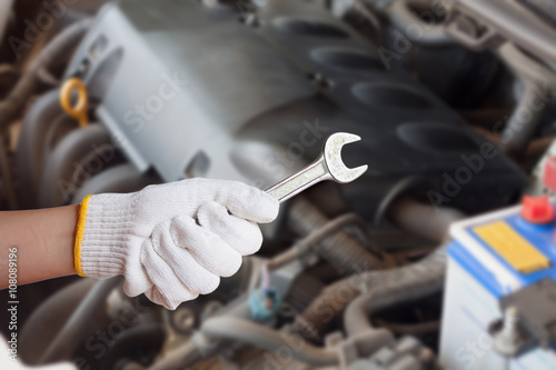 Hand of auto mechanic with wrench