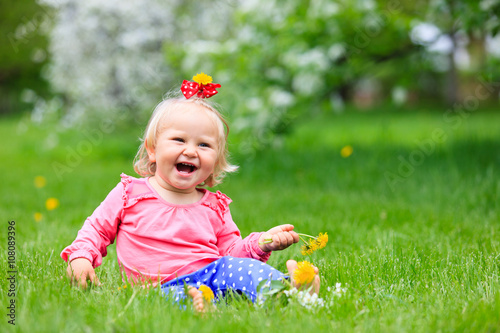 happy little girl with flowers in spring