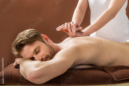 Fotografering Young Man Receiving Back Massage At Spa