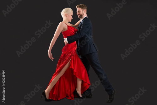 Young Couple Dancing On Black Background