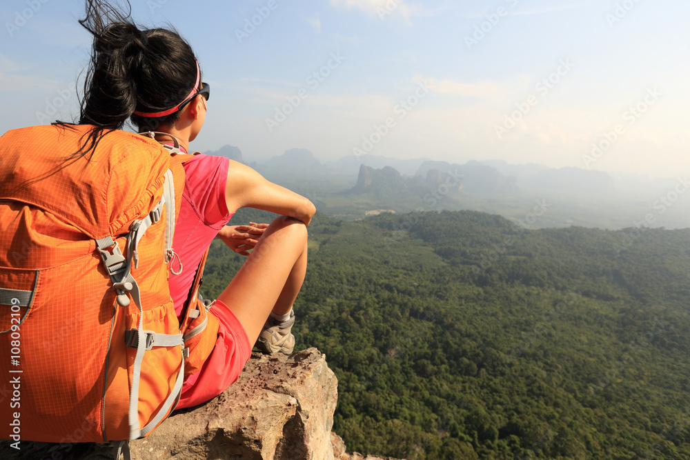 Naklejka premium successful woman hiker enjoy the view on mountain top