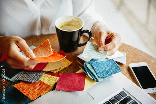 Mixed race designer examining fabric swatches