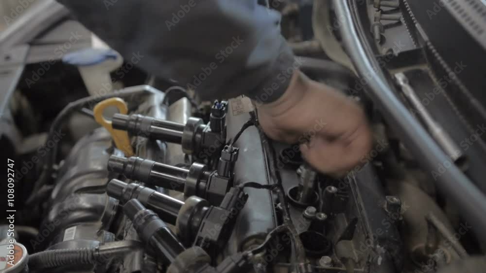 Auto Mechanic is Working on Engine in Car Repair Shop. Auto Mechanic is Working on Engine in Car Repair Shop.