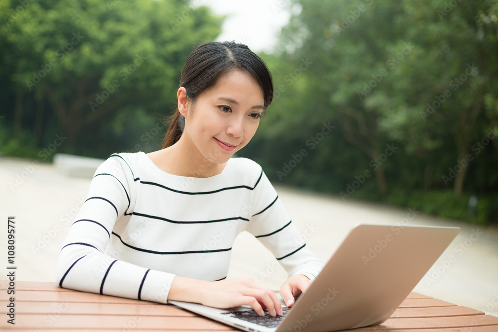 Woman working on notebook computer Woman working on notebook computer
