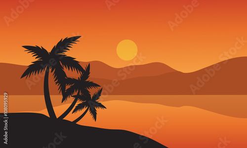 Tree palm trees silhouette on sunset tropical beach