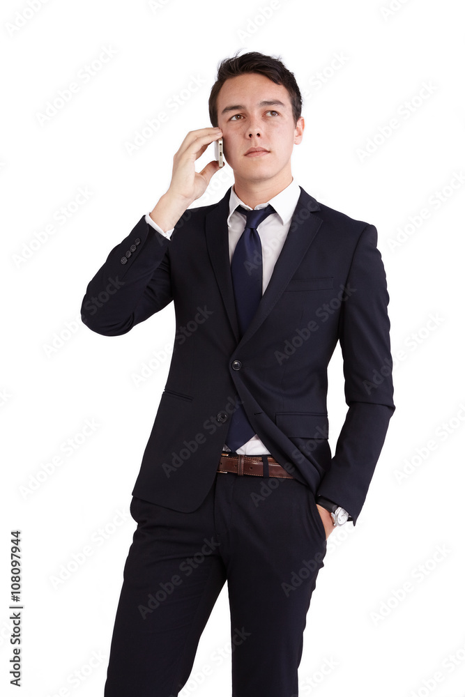 A young caucasian male businessman looking unhappy holding a mobile phone looking away from camera. A young caucasian male businessman looking unhappy holding a mobile phone looking away from camera.