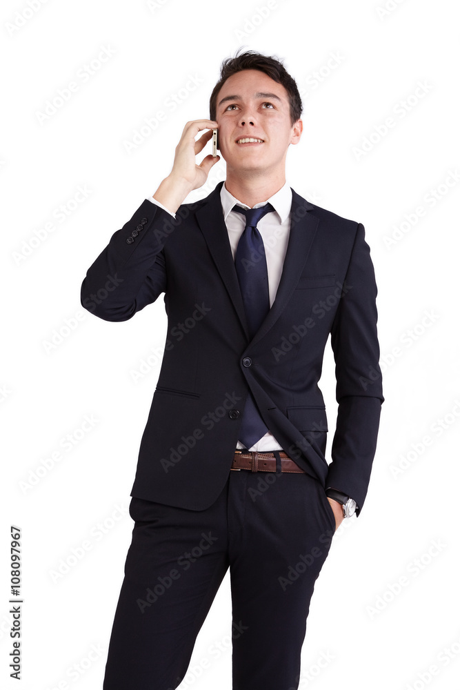 A young caucasian male businessman looking happy holding a mobile phone looking away from camera. A young caucasian male businessman looking happy holding a mobile phone looking away from camera.