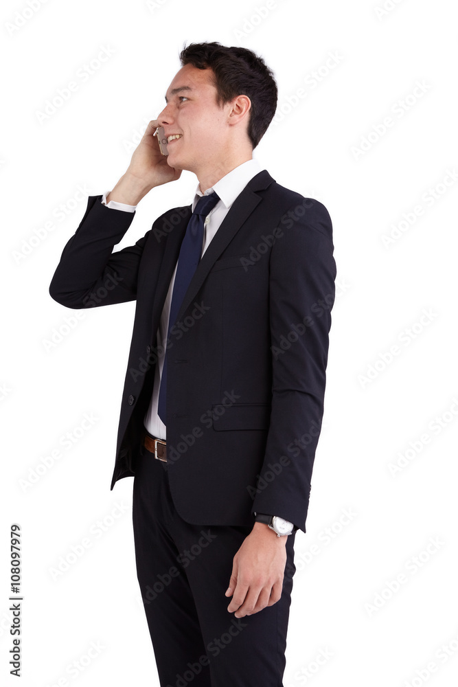 A young caucasian male businessman looking happy holding a mobile phone looking away from camera. A young caucasian male businessman looking happy holding a mobile phone looking away from camera.
