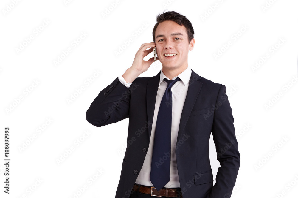 A young caucasian male businessman smiling holding a mobile phone looking at camera. A young caucasian male businessman smiling holding a mobile phone looking at camera.