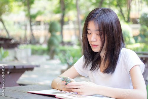 asia thai china student university beautiful girl using her smart phone.