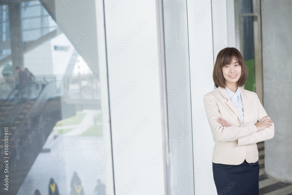 Attractive asian business woman smiling outside office Attractive asian business woman smiling outside office