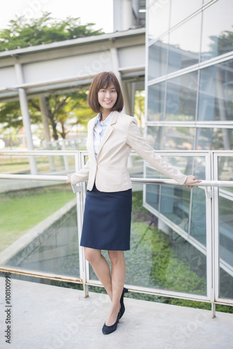 Attractive asian business woman smiling outside office © tonefotografia