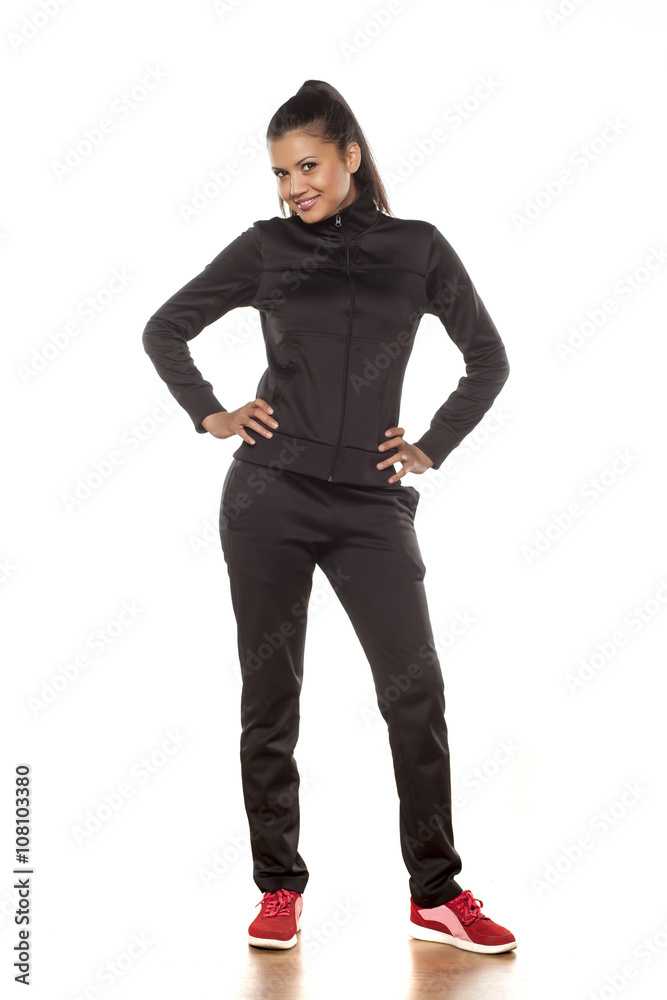 young pretty woman in tracksuits posing in the studio young pretty woman in tracksuits posing in the studio