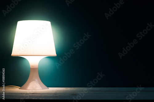 Lamp night light in a dark background. Vintage effect style picture.