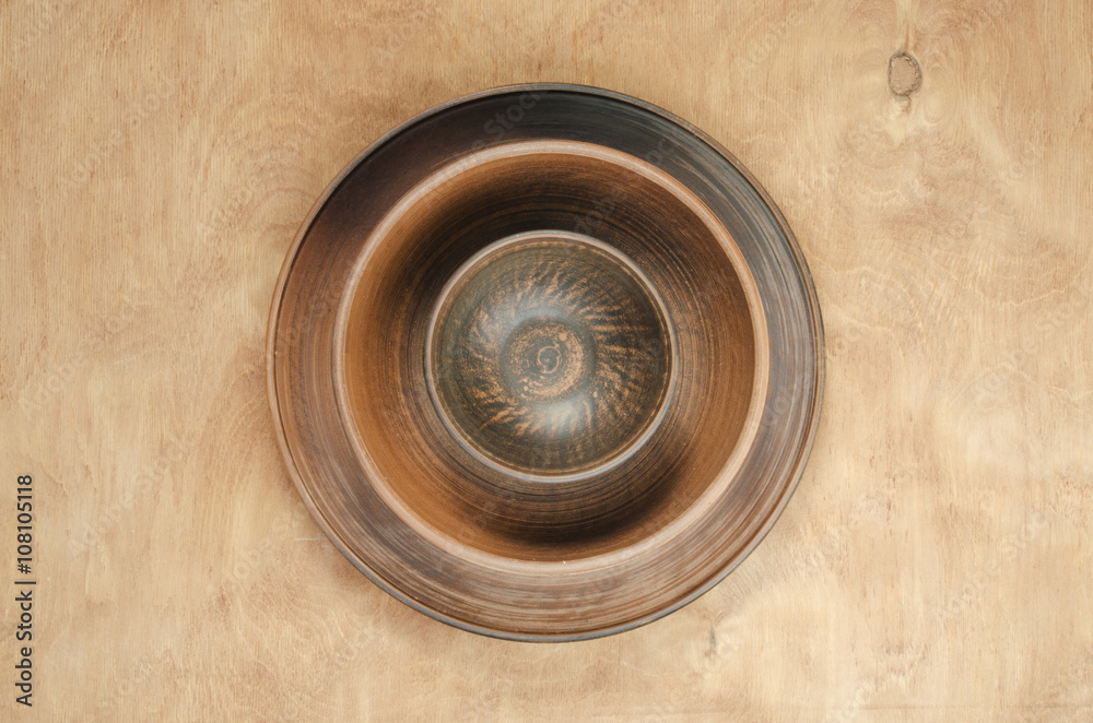 Home Kitchen Decor: the ceramic plates on a wooden background. Top view. Rustic style.