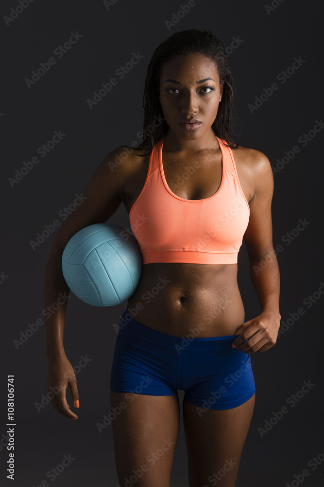 African American woman holding volleyball African American woman holding volleyball