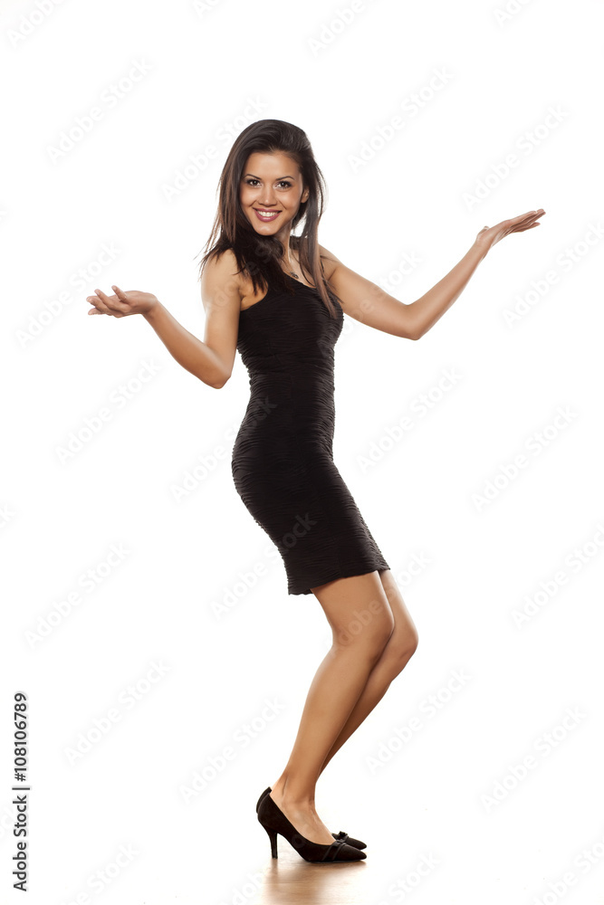 young and happy beautiful lady posing in short black tight dress young and happy beautiful lady posing in short black tight dress