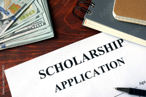 Scholarship Application on a table and dollars.