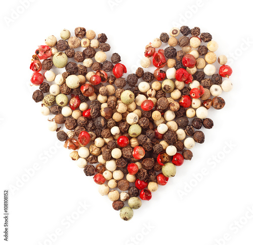 spices color pepper heart shape on white
