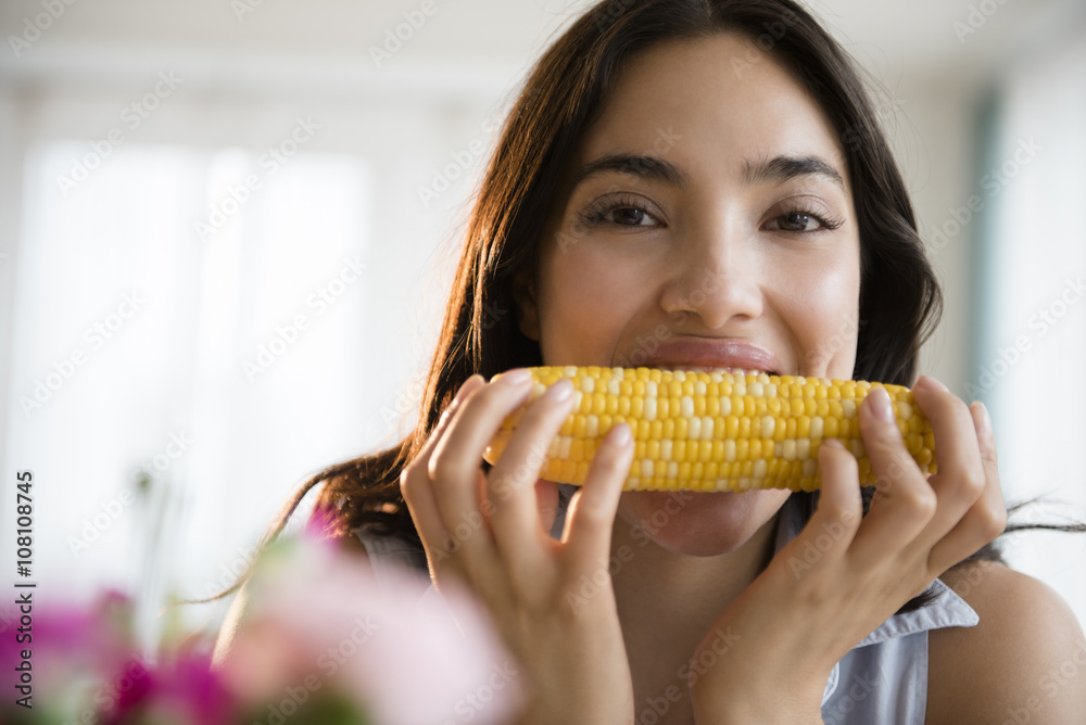 Hispanic woman eating corn on the cob Hispanic woman eating corn on the cob
