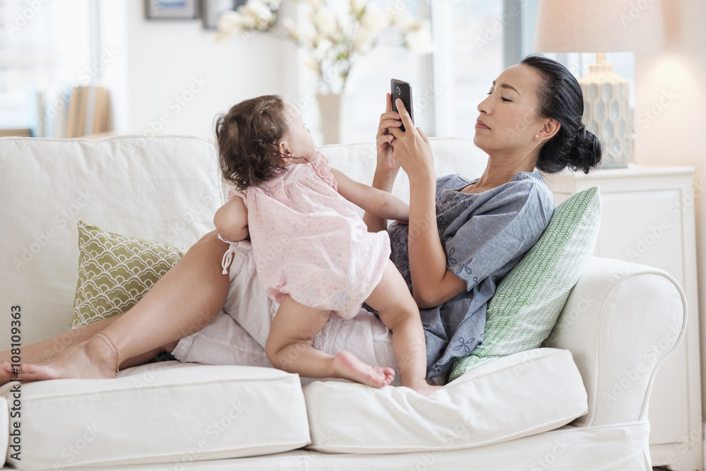 Mother photographing baby daughter Mother photographing baby daughter