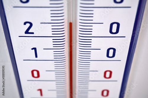 
Aged outdoor thermometer in the retro design measuring mild temperature of twenty degrees of Celsius  photo