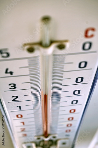 
Aged outdoor thermometer in the retro design measuring mild temperature of twenty degrees of Celsius  photo