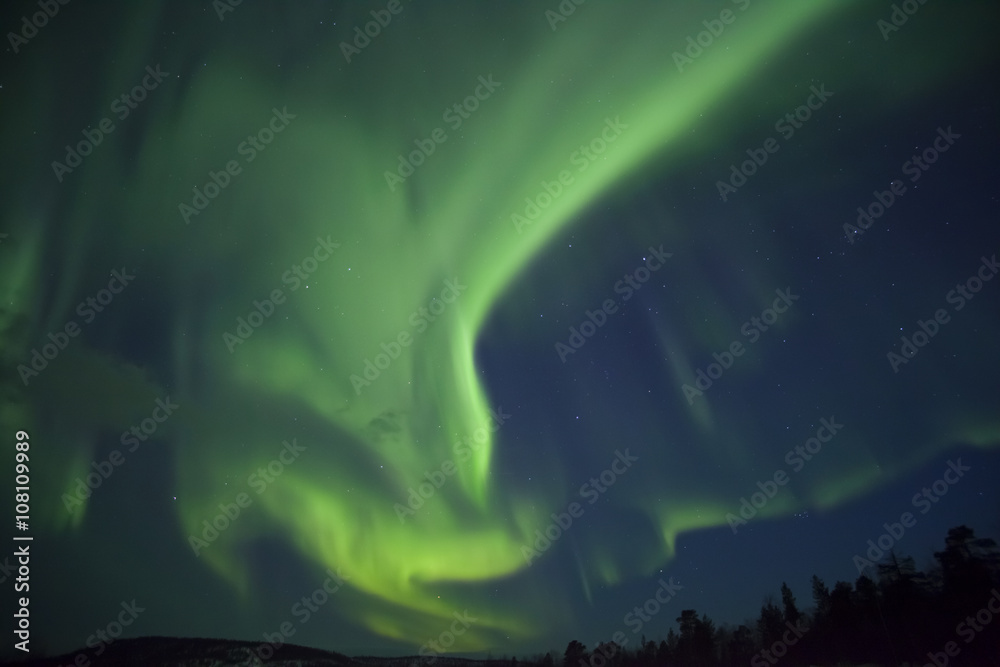 Aurora Borealis with green and purple light at Inari lake, finland, Lapland, natural spectacle at night