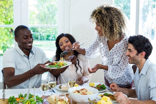 Woman serving food to her friends