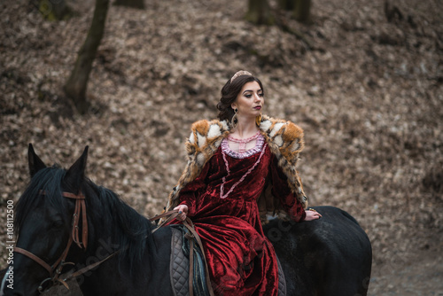 Princess with her horse in the woods